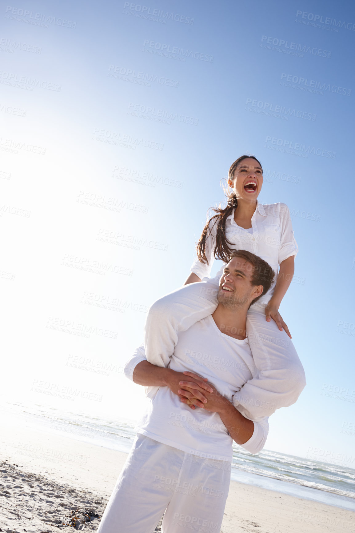 Buy stock photo Happy couple, beach and piggyback with blue sky for love, valentines day or summer holiday together in embrace or outdoor romance. Man and woman with smile by ocean coast in nature on mockup space