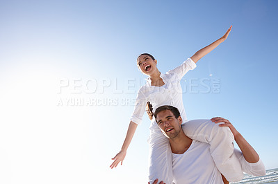 Buy stock photo Cropped shot of a young man carrying his girlfriend on his shoulders