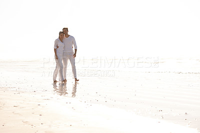 Buy stock photo Happy couple, hug and walking with beach for love, embrace or valentines day in nature. Man and woman enjoying stroll by the ocean coast or sea for holiday, date or weekend together with mockup space