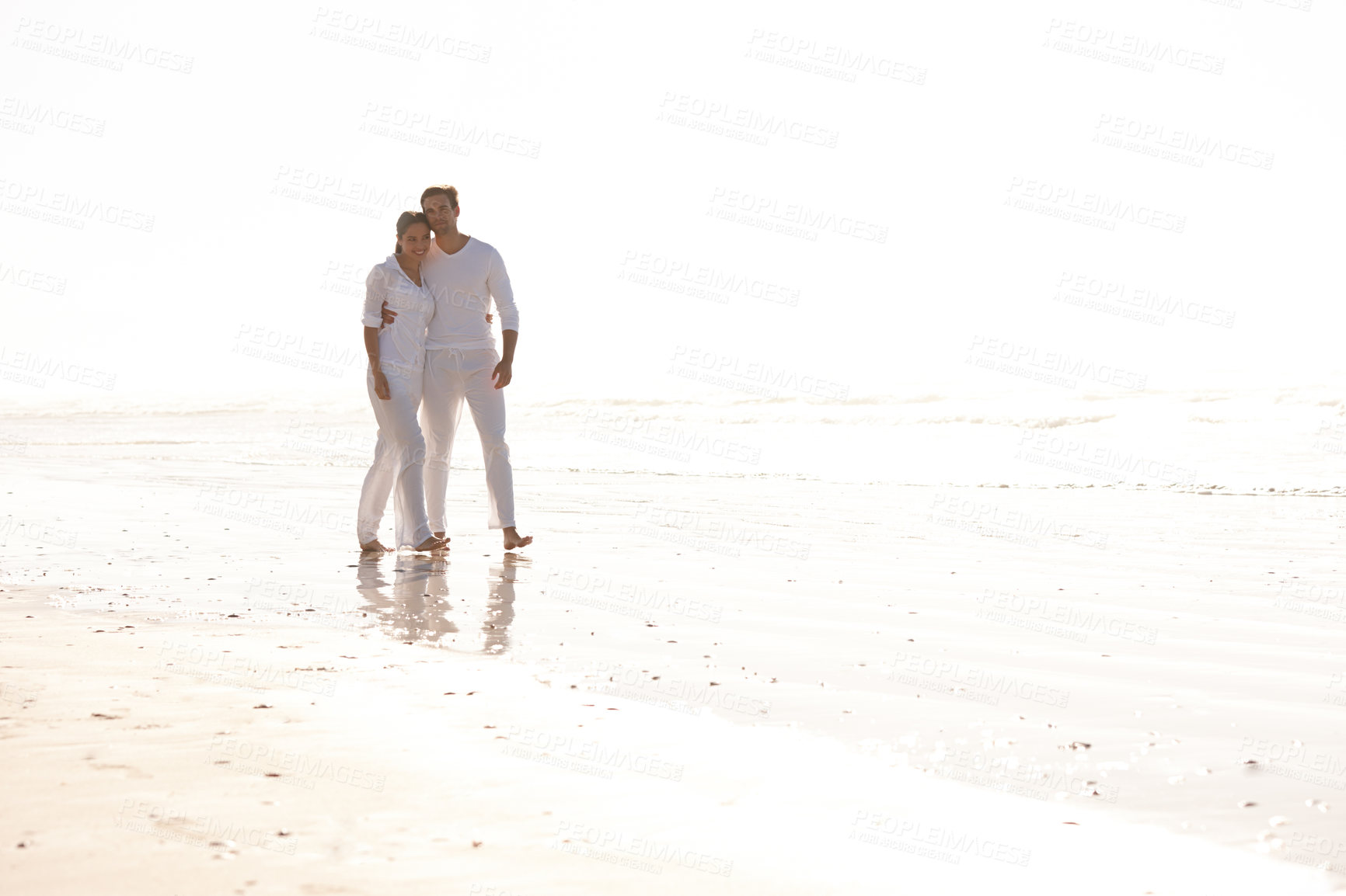 Buy stock photo Happy couple, hug and walking with beach for love, embrace or valentines day in nature. Man and woman enjoying stroll by the ocean coast or sea for holiday, date or weekend together with mockup space