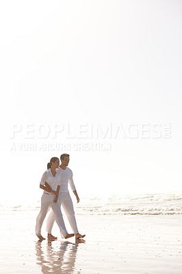 Buy stock photo Couple, walking and beach with hug for love, embrace or valentines day in outdoor nature. Man and woman enjoying stroll by the ocean coast or sea for holiday, date or weekend together on mockup space