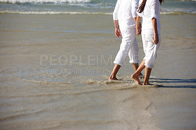 Buy stock photo Walking, beach and legs of couple in waves for summer holiday, vacation and weekend by ocean. Travel, sunset and feet of man and woman holding hands in water for bonding, relax and relationship