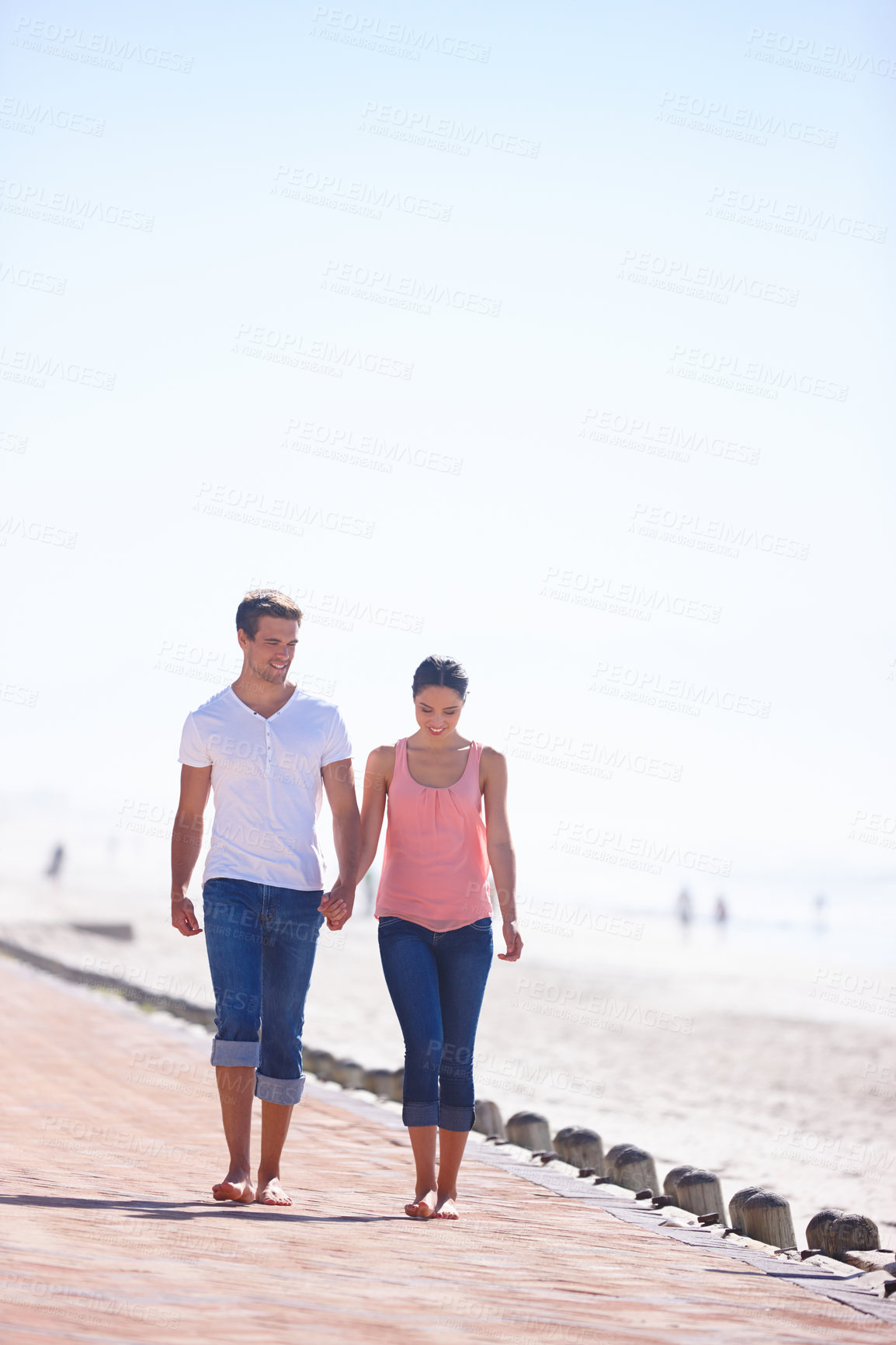 Buy stock photo Man, woman and holding hands with walking on beach, romantic date and commitment with trust. Love, care and people together outdoor for anniversary, bonding and relax by sea with partner for travel