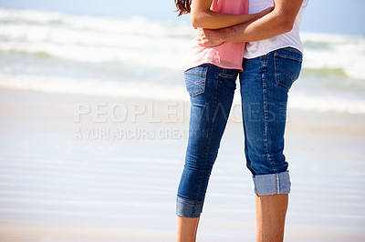 Buy stock photo Couple, legs and hug on sand at beach with romance, anniversary date and honeymoon travel on mockup space. People, love and embrace with jeans, relax and bonding by ocean for summer holiday in Bali