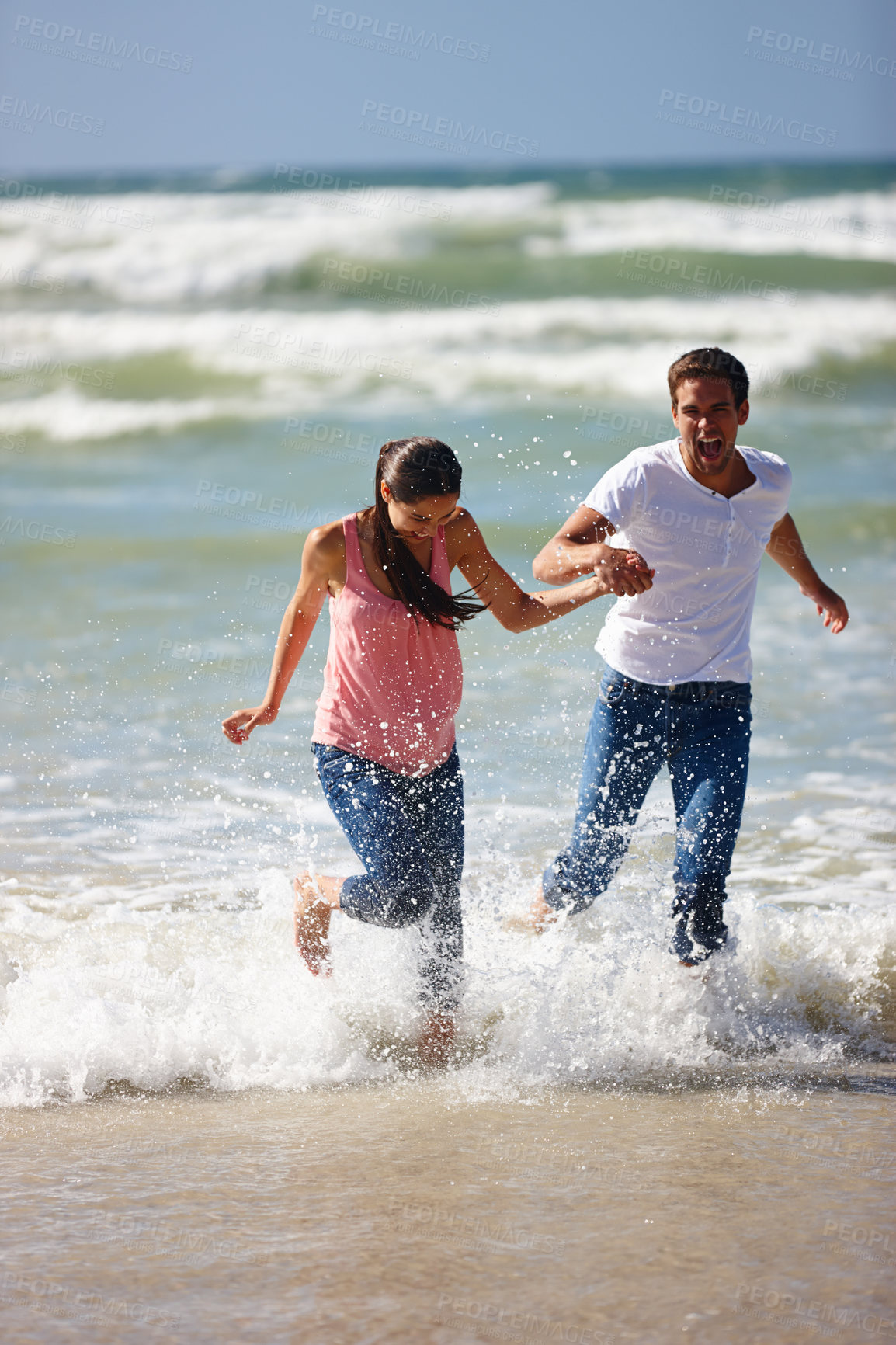 Buy stock photo Holding hands, love and couple at a beach running for adventure, fun or bonding in nature. Water splash, ocean or people at sea with energy, freedom or romance on travel, journey or vacation together