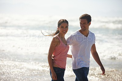 Buy stock photo Hug, love and couple at a beach walking, calm and bonding on ocean adventure together. Travel, sunset and people at sea embrace with care, support and trust for summer, holiday or journey in nature