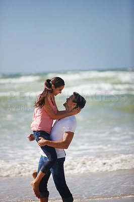 Buy stock photo Happy couple, hug and beach with love for romance, care or support on outdoor holiday, vacation or break in nature. Man lifting woman for embrace or relationship on weekend by ocean coast on mockup