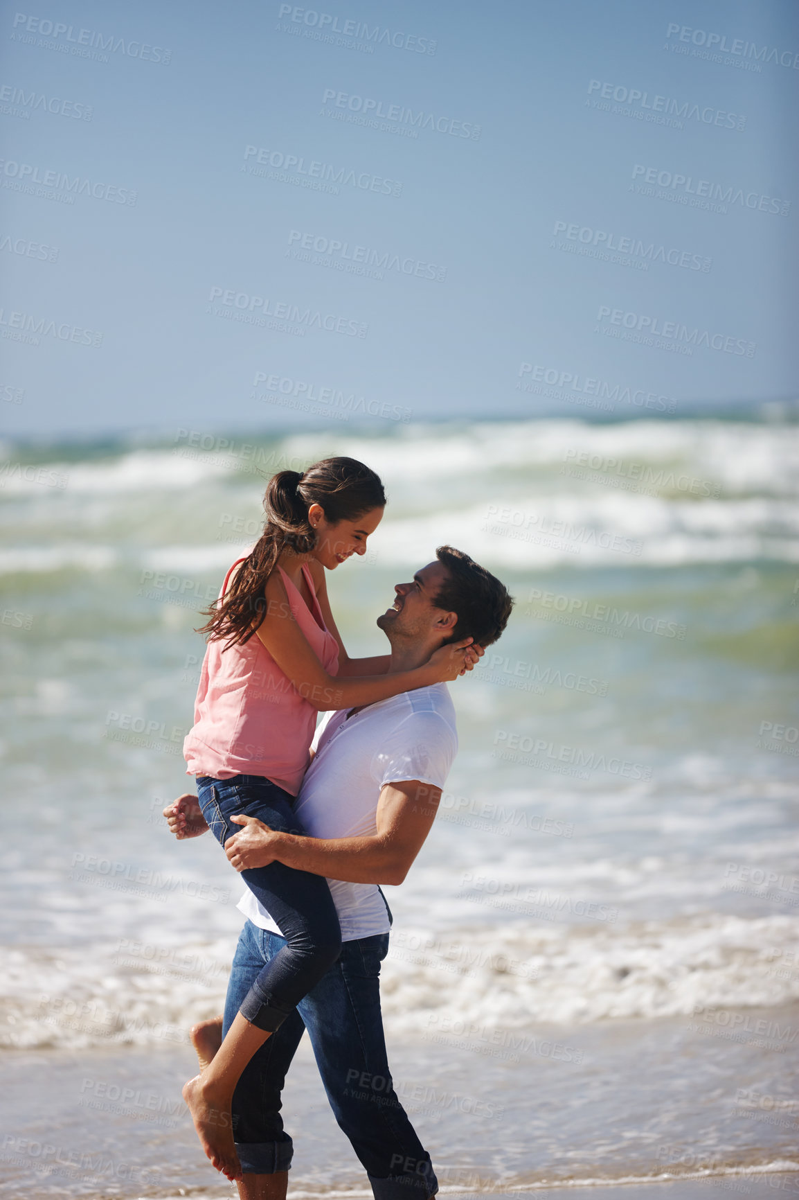 Buy stock photo Happy couple, hug and beach with love for romance, care or support on outdoor holiday, vacation or break in nature. Man lifting woman for embrace or relationship on weekend by ocean coast on mockup