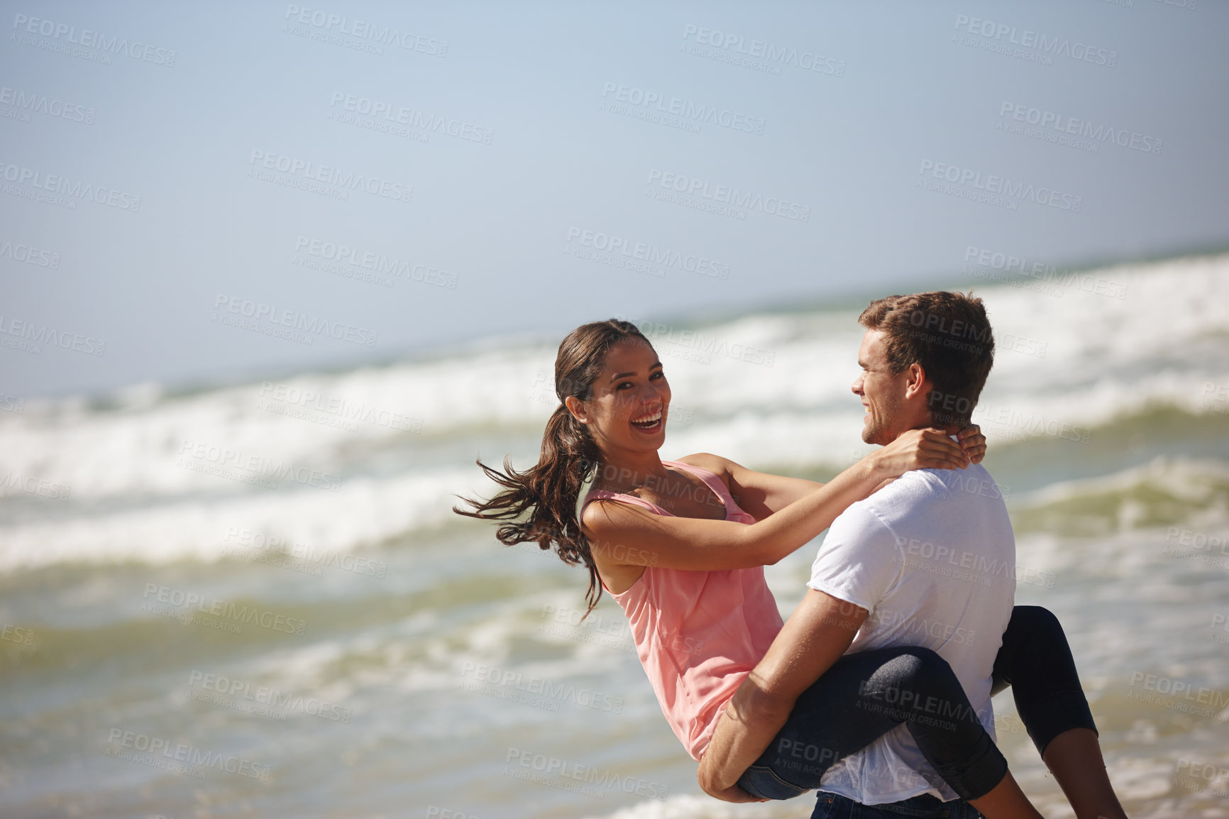 Buy stock photo Happy couple, hug and beach with love for support, care or embrace on holiday, weekend or outdoor vacation. Man carrying woman with smile for relationship, summer fun or bonding by the ocean coast