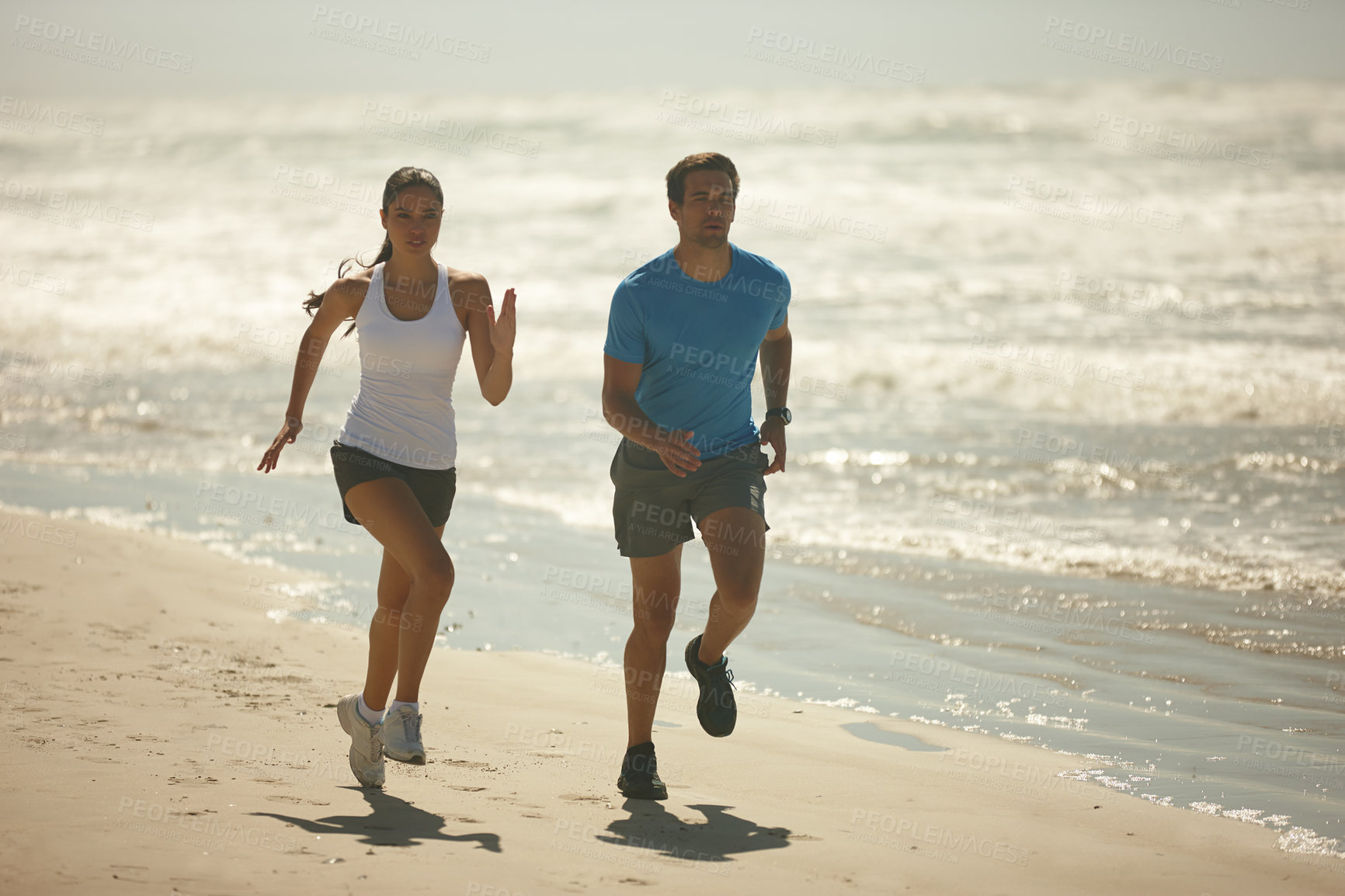 Buy stock photo Couple, fitness and running on beach with exercise, workout or outdoor training together in nature. Man and woman enjoying walk or run for physical activity or cardio on the ocean coast with partner