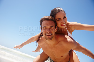 Buy stock photo Happy, portrait and couple flying with piggy back at the beach with love and support on holiday in summer. Laugh, sea and vacation with smile and bonding by water with travel in Miami with people