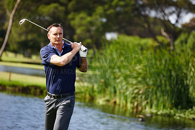 Buy stock photo Man, swing and golfer with club by lake for point, score or par shot in outdoor nature. Male person or sports player hitting ball in competition, challenge or practice on grass field or golf course