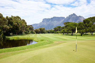 Buy stock photo Hole, flag and grass at golf course in landscape of summer on luxury holiday or vacation. Calm, morning and lawn with turf for sport in woods, forest or nature of park with water, trees and field