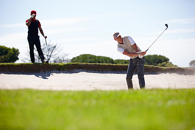 Buy stock photo Man, friends and playing golf with club for stroke, point or strike in sand pit by grass field in nature. Male person, golfer or sports player with swing in dirt for ball, game or outdoor match