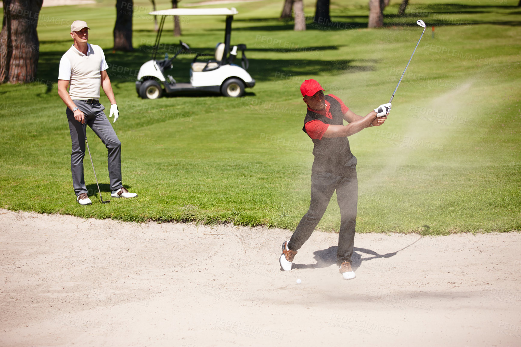 Buy stock photo Men, stroke and golf ball in bunker on summer day for sports, health or exercise outdoor in activewear. People, training and playing game of nine holes on natural turf athlete in sand swinging club