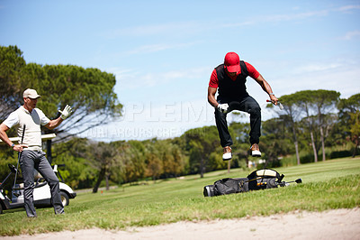 Buy stock photo Shot of a frustrated golfer jumping on his golf bag