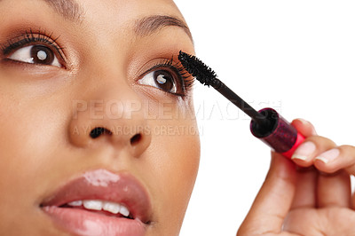 Buy stock photo Cropped shot of a gorgeous young woman applying mascara in a studio-isolated on white 
