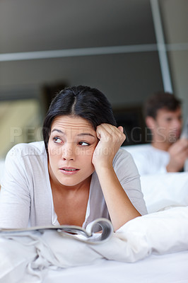 Buy stock photo Woman, annoyed and bed with magazine and boyfriend for thinking, couple or angry for breakup or argument in home. Mexican female person and frustrated with thought for stress mindset with partner