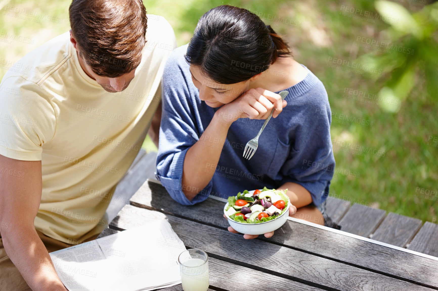 Buy stock photo Cropped shot of a young couple spending time together outdoors on a sunny day 