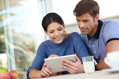 Buy stock photo Cropped shot of an affectionate couple using a digital tablet together