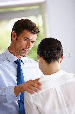 Buy stock photo Cropped shot of a handsome man comforting his distressed coworker 