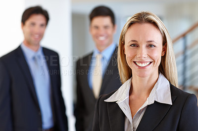 Buy stock photo Businesswoman, portrait and colleagues with smile at office for work, joy or young and confident. Female person, coworkers and happy at job with real estate or property, realtor or professionals