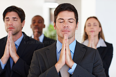 Buy stock photo Business people, pray and meditation with hands together in team for faith, calm or company peace at office. Young businessman, colleagues or coworkers meditating in belief, spiritual wellness or zen