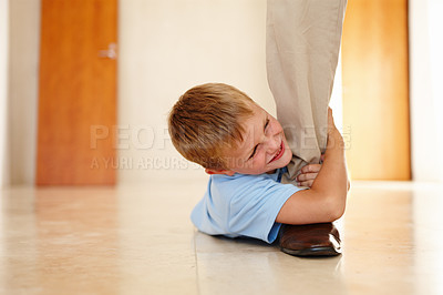 Buy stock photo Child, happy and holding dads leg on floor for playing, bonding or family game at home. Kid, smiling and on ground pulling fathers foot for entertainment, amusement or relationship development