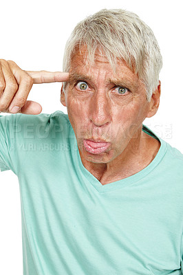 Buy stock photo Senior man, portrait and crazy face in studio for comic, funny and comedy with finger pointing on head. Elderly person, joke and facial expression for humor or silly on isolated white background