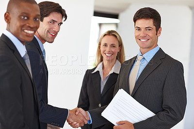 Buy stock photo Business, document and handshake with colleagues and smile for deal, realtor or property or investment. Male person, team or shaking hands at house with paper or agreement, real estate with diversity