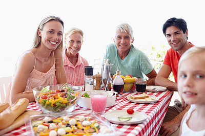 Buy stock photo Portrait, family and young girl in living room at table with salad, vegetables and eating together for lunch. Mom, dad and child on vacation at childhood house visiting grandparents for memory