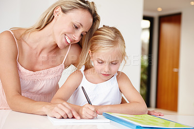 Buy stock photo Parent, happy and girl writing in book for development, learning or educational growth. Mom, smiling and child studying notebook in living room together for homework, examination or schoolwork