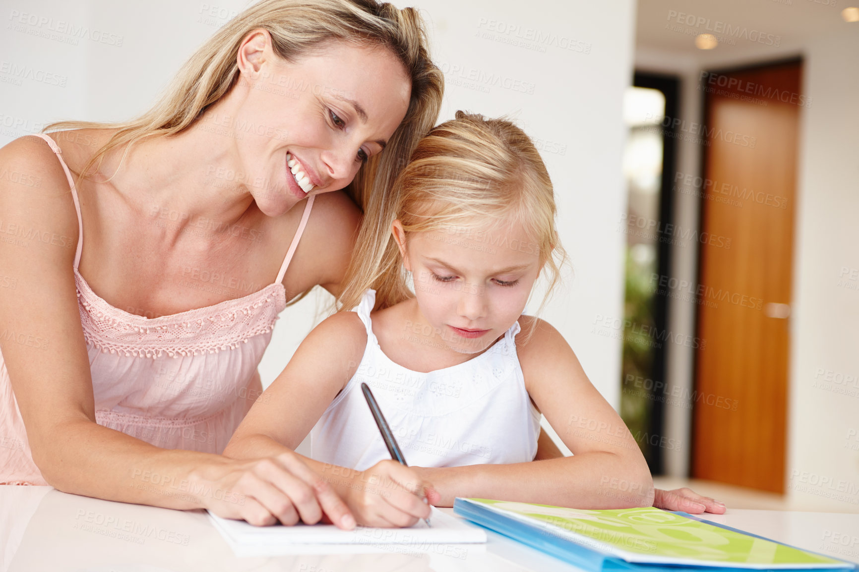 Buy stock photo Parent, happy and girl writing in book for development, learning or educational growth. Mom, smiling and child studying notebook in living room together for homework, examination or schoolwork
