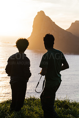 Buy stock photo Men, silhouette and mountain with sunset, ocean or travel in summer, vacation or outdoor for horizon view. People, hiking adventure and rest on hill for sea, sunshine or relax on holiday with freedom