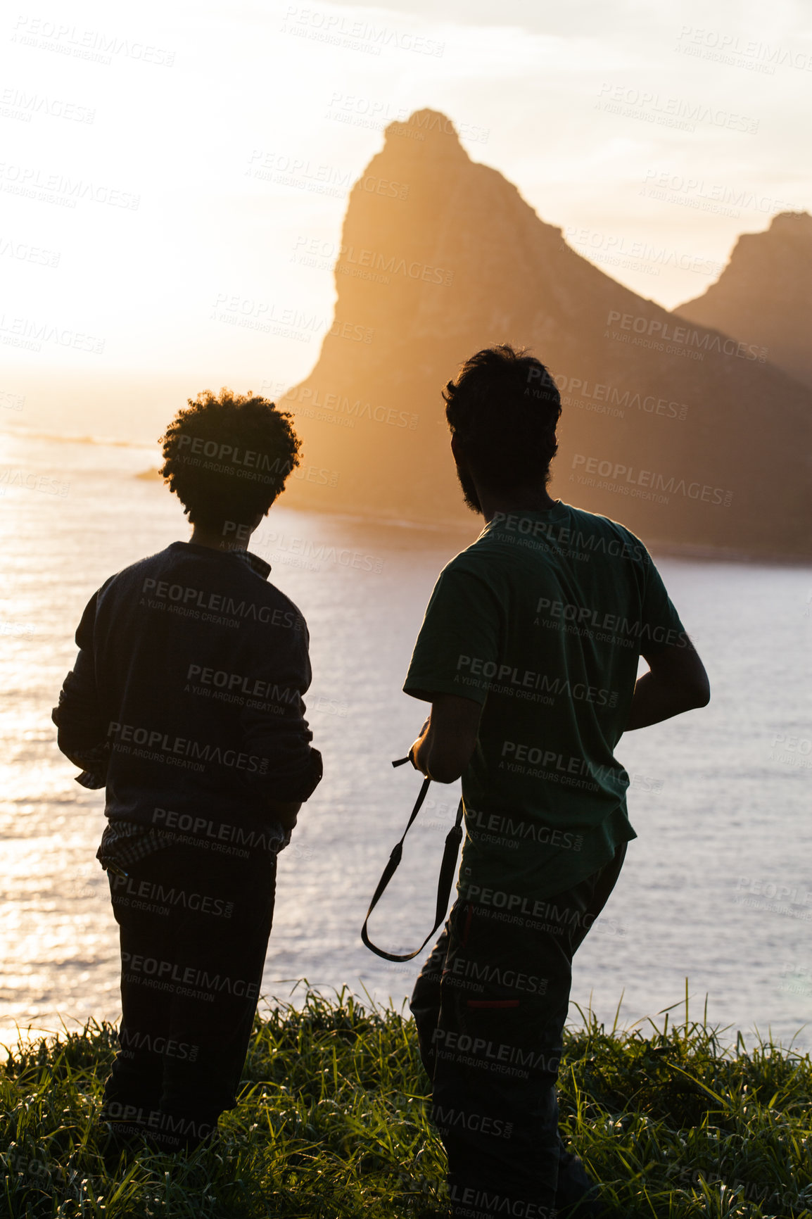 Buy stock photo Men, silhouette and mountain with sunset, ocean or travel in summer, vacation or outdoor for horizon view. People, hiking adventure and rest on hill for sea, sunshine or relax on holiday with freedom