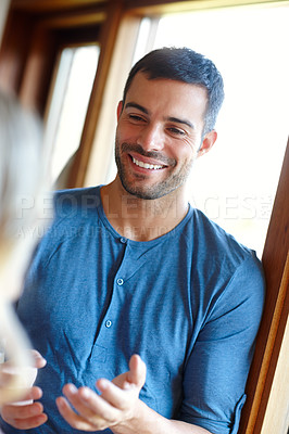 Buy stock photo Man, happiness and laughing in living room for relax, conversation and communication with confidence. Male person, cheerful and talking in house for humour, enjoyment and morning routine with partner