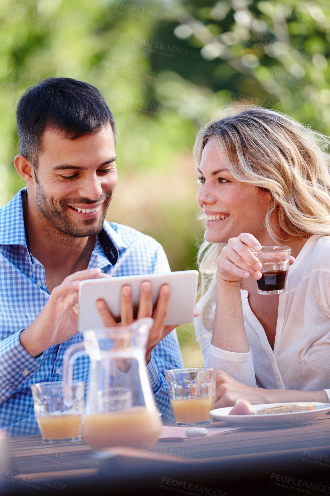 Buy stock photo Happy couple, smiling and tablet in garden for breakfast, internet and scrolling on social media. Male person, woman and outdoors at home for mobile games, meme and communication in the morning