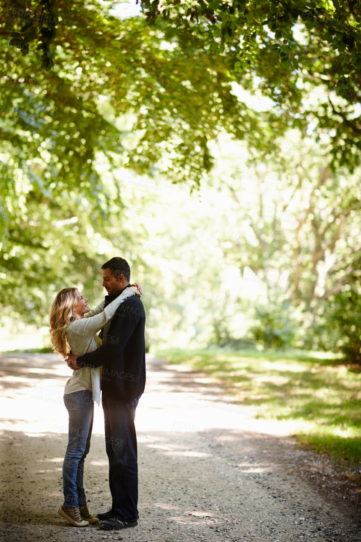 Buy stock photo Couple, care and outdoor marriage in park, together and love in relationship or bonding in embrace. Happy people, support and hug on holiday or vacation in nature, relax and commitment on date