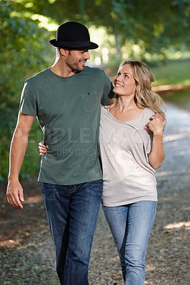 Buy stock photo Couple, hug and happy walking in park for bonding, love with care and support in healthy relationship. Man, woman and outdoor for date with romance, trust and commitment for marriage or partner