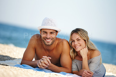 Buy stock photo Couple, portrait and relax on sand or vacation, smile and peace at beach or lying by water. People, happy and tropical ocean for bonding on weekend, outdoor nature and love for marriage or romance