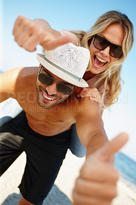 Buy stock photo Couple, thumbs up and portrait at beach for travel outdoor, agree for break and relax for relationship. Boyfriend, girlfriend or tourist and showing yes sign and smile by ocean for summer holiday 