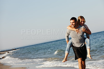 Buy stock photo Couple, ocean water and piggyback on vacation, smile and peace at beach or game by blue sky. People, happy and tropical island for bonding on weekend, outdoor nature and love for marriage or romance