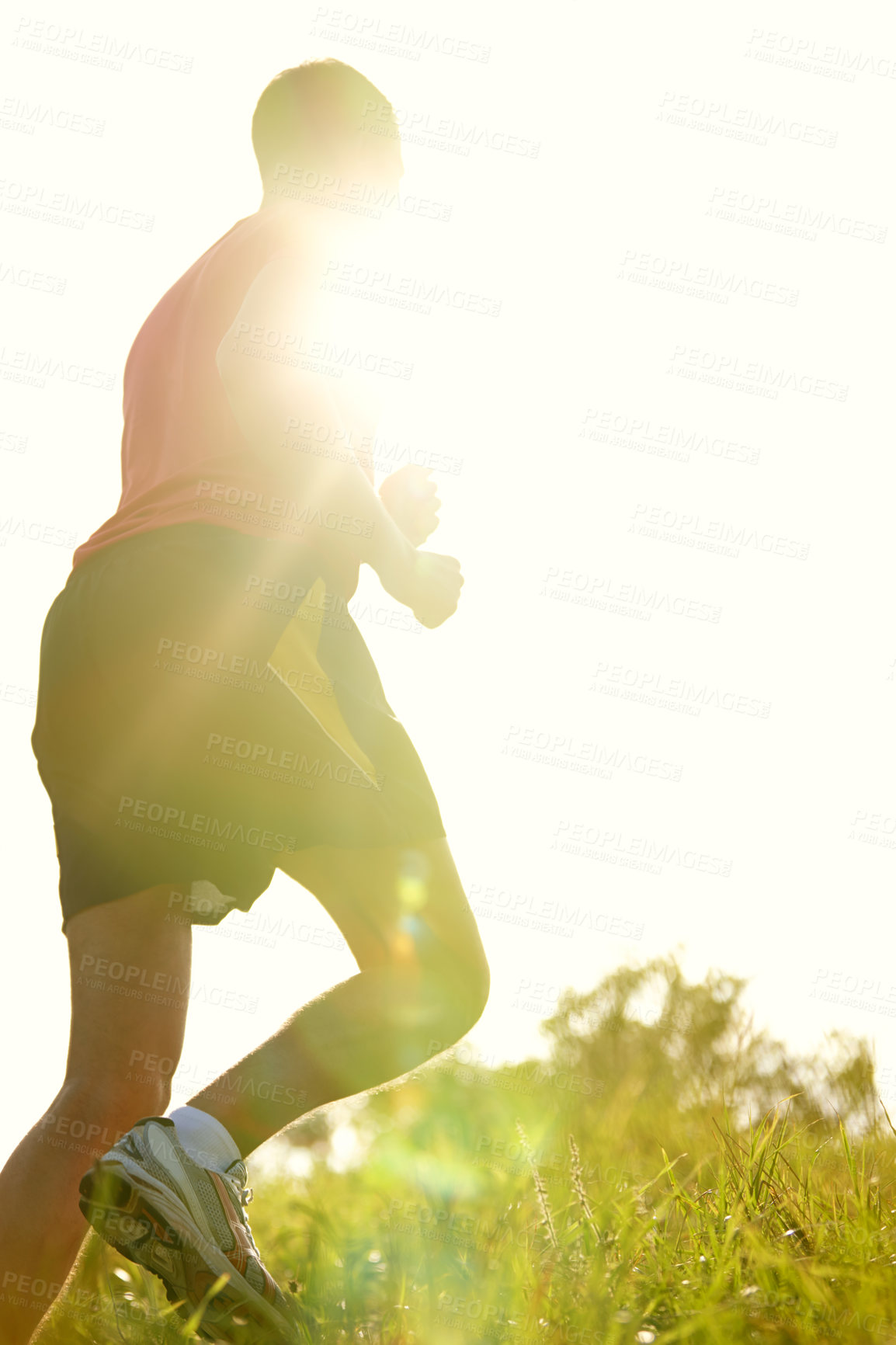 Buy stock photo Rearview shot of a young man running outdoors on a mountain trail