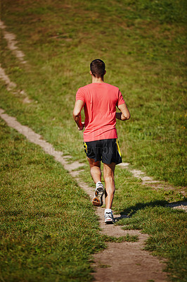 Buy stock photo Sporty, man and jogging in outdoor for fitness, health and running in nature for workout or exercise. Male athlete, training and cardio with endurance, muscles and strength for healthy living or gym