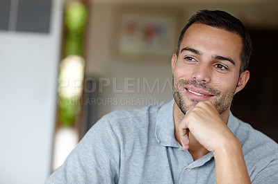 Buy stock photo Shot of an attractive, smiling young man at home 