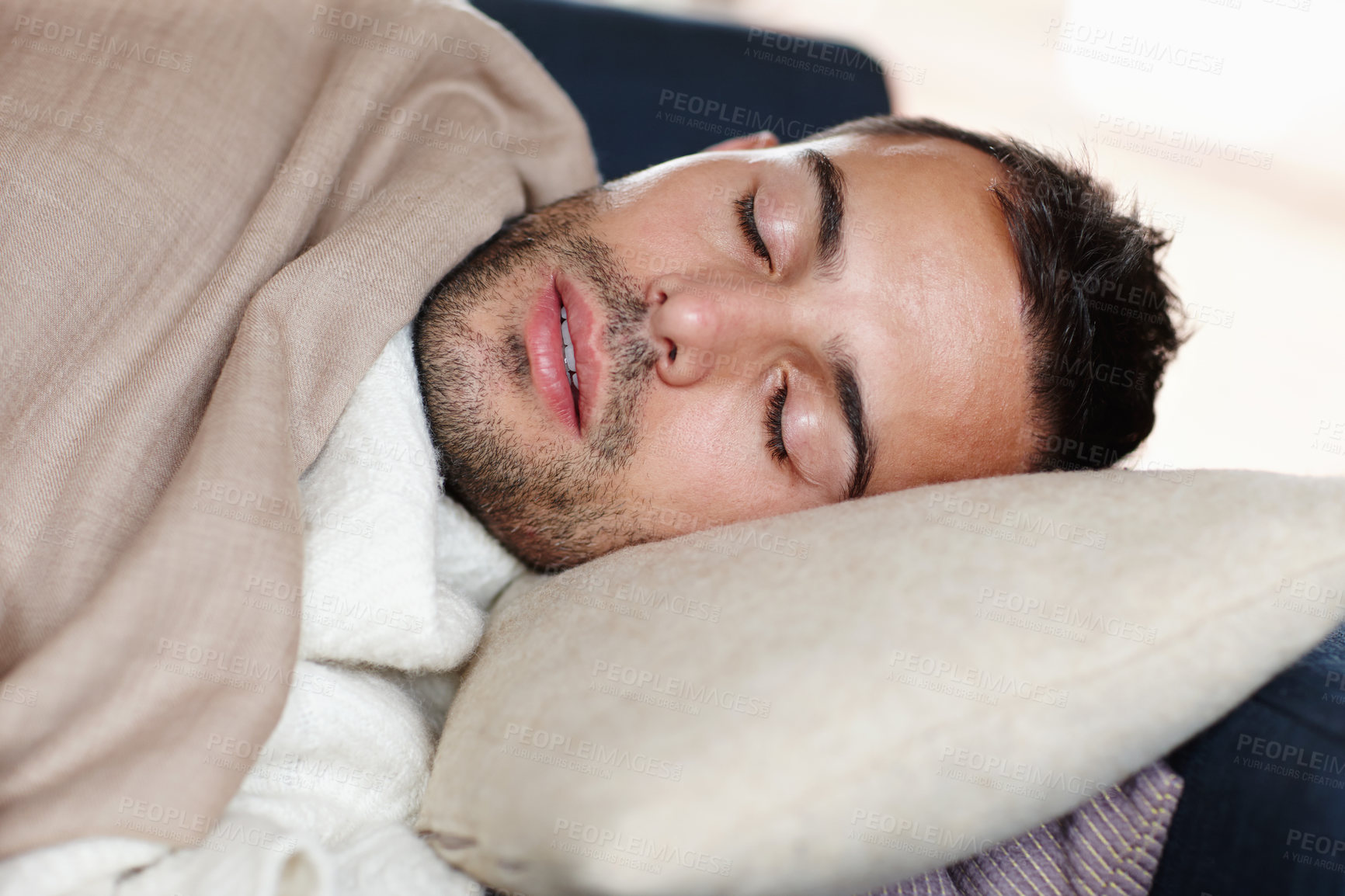 Buy stock photo Man, sleeping and resting with tired, fatigue and burnout on sofa with pillow, blanket and winter. Male person, exhausted and eyes closed at home on weekend with comfort, cozy and relaxed for health