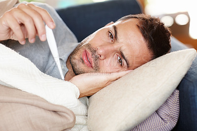 Buy stock photo Man in couch, sick and thermometer for fever, healthcare and wellness with virus, viral infection or bacteria at home. Burnout, fatigue and health fail, monitor condition for illness with cold or flu