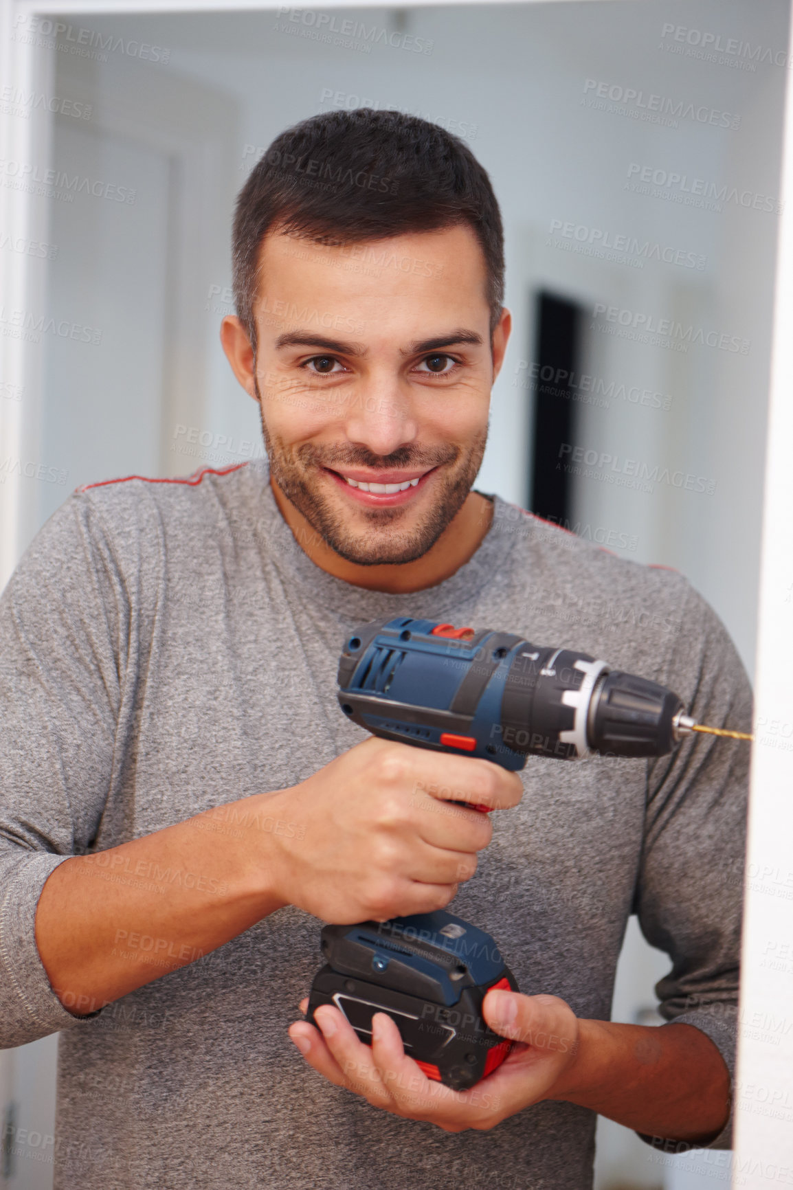 Buy stock photo Man, portrait and drill for repair in home, electric tools and handyman service for renovation. Male person, contractor and diy or equipment for house improvement, smile and hobby for craftsman