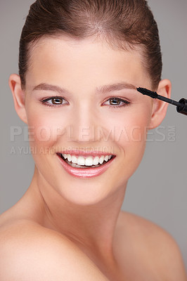 Buy stock photo Makeup, cosmetics and portrait of woman with mascara in studio for wellness, skincare product or beauty on grey background. Smile, application and model by eyelash wand for glamour, makeover or glow