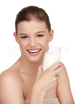 Buy stock photo Woman, glass of milk and smile in studio portrait for healthcare, skincare or beauty and cosmetics. Female person, happy or satisfied with cup of dairy for immune system, dermatology and wellness